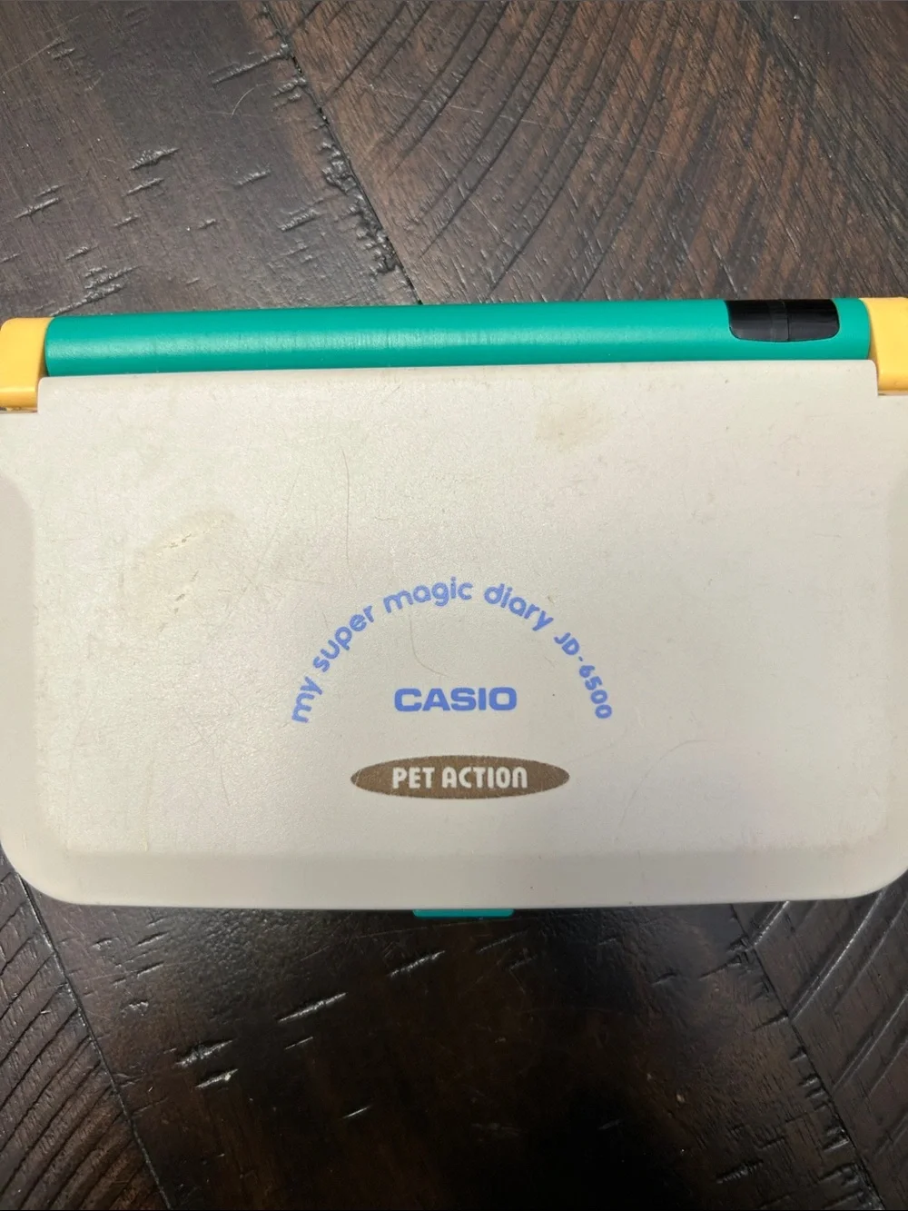 Vintage Casio Pet Action Handheld Diary in Teal, Yellow & Cream.  Not tested